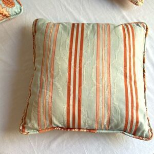 Orange and blue decorator pillow, 15 x 15”